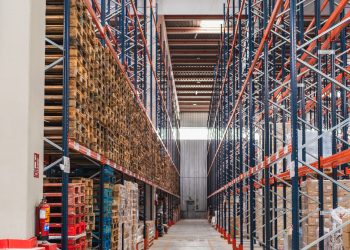 Goods stored on tall shelves inside a modern logistics warehouse, ensuring efficient organization and distribution